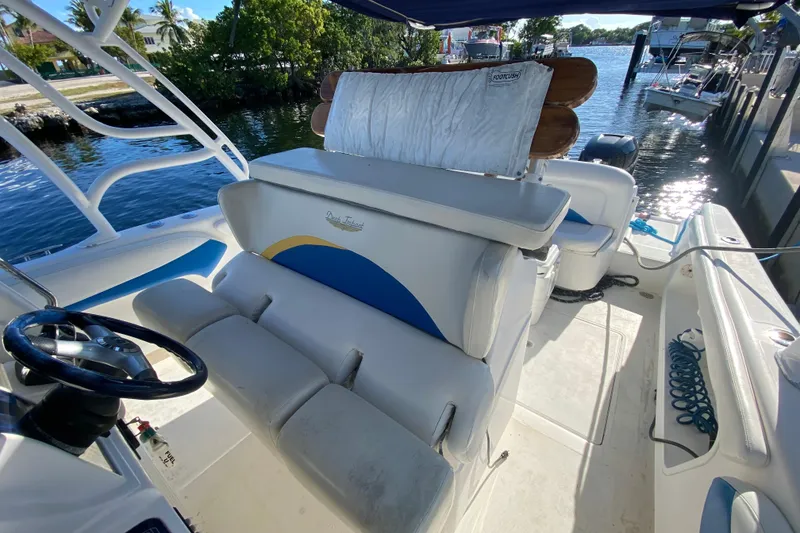Slide: The Image of 2004 Deep Impact 36 DI boat interior with seating and steering wheel, docked by the water. - 20