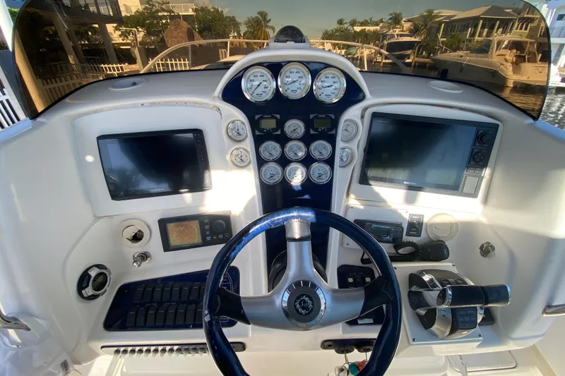 Slide: The Image of 2004 Deep Impact 36 DI boat dashboard with gauges, steering wheel, and navigation screens. - 22