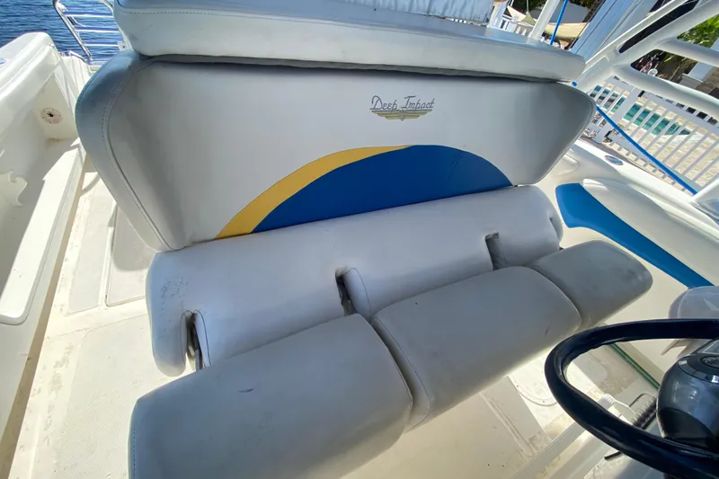 Slide: The Image of 2004 Deep Impact 36 DI boat seating with logo and blue-yellow design. - 23