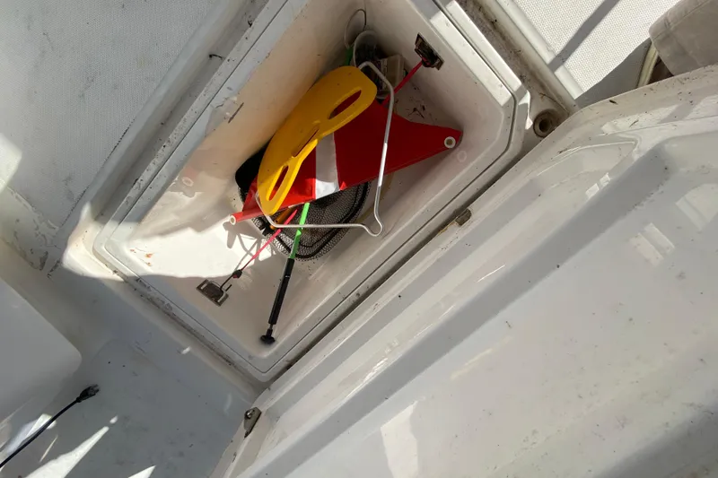 Slide: The Image of Storage compartment on 2004 Deep Impact 36 DI boat with safety equipment. - 27