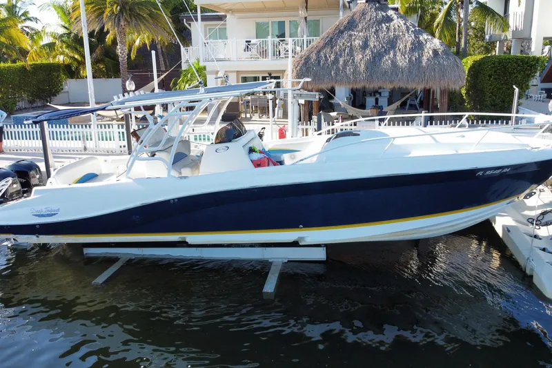 Slide: The Image of 2004 Deep Impact 36 DI boat docked near tropical waterfront home. - 3