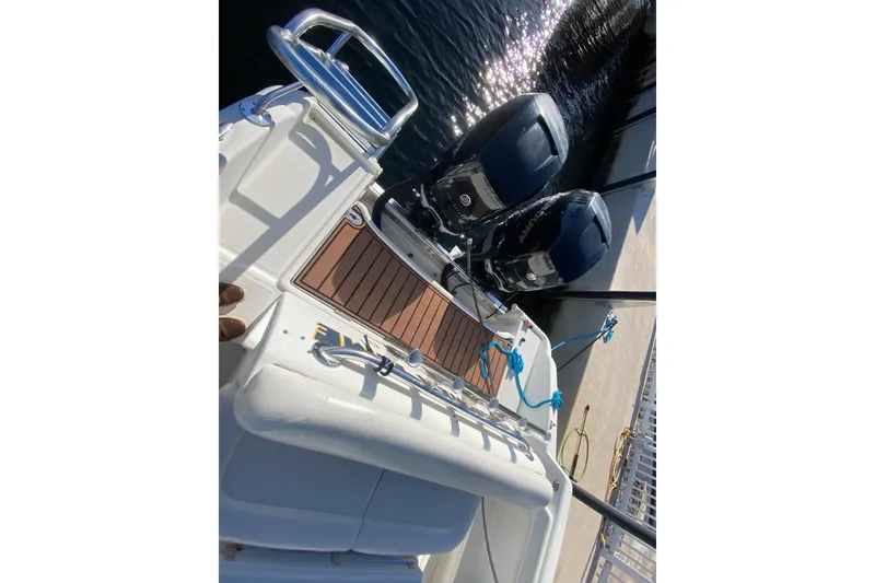 Slide: The Image of 2004 Deep Impact 36 DI boat with dual outboard motors docked at marina. - 38