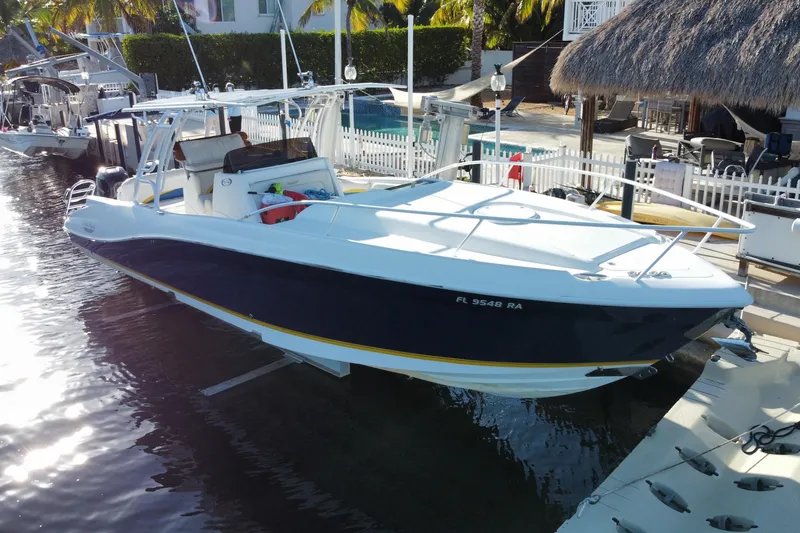 Slide: The Image of 2004 Deep Impact 36 DI boat docked by a waterfront property. - 7