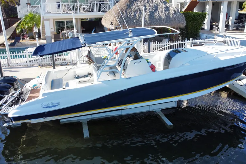Slide: The Image of 2004 Deep Impact 36 DI boat docked with blue canopy and sleek design. - 9