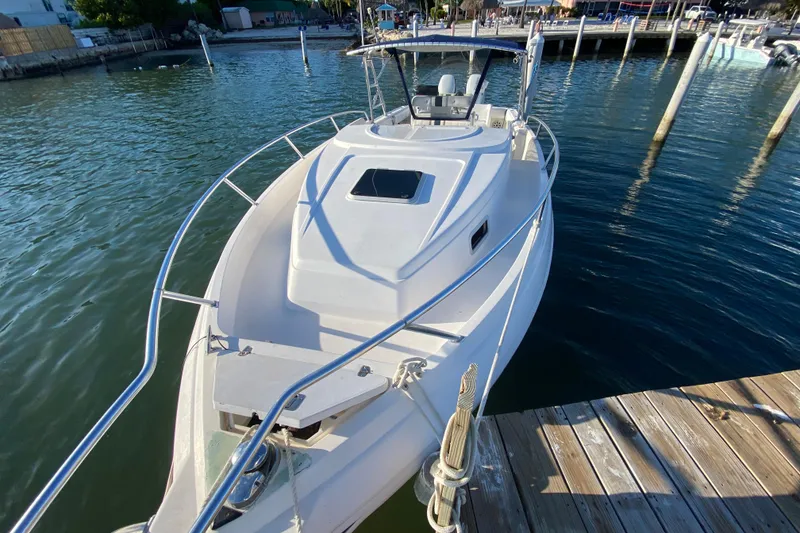Slide: The Image of 1998 Intrepid 339 boat docked at marina, viewed from the bow. - 16