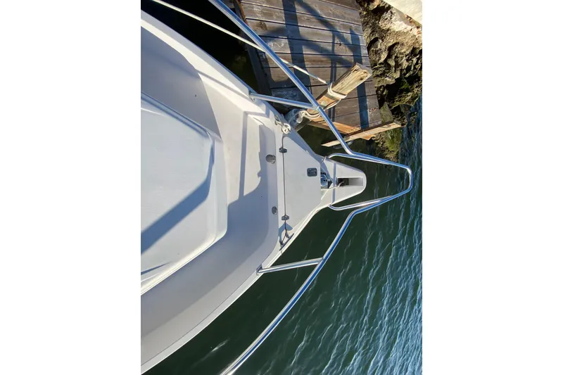 Slide: The Image of Bow view of 1998 Intrepid 339 boat docked by wooden pier. - 17