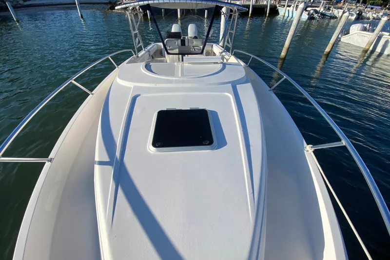 Slide: The Image of 1998 Intrepid 339 boat deck view at marina, showcasing sleek design and spacious layout. - 18