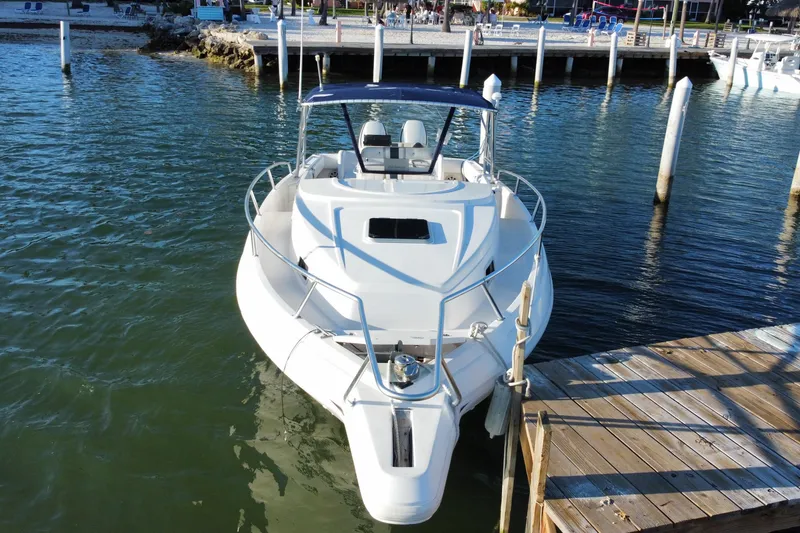 Slide: The Image of 1998 Intrepid 339 boat docked at a marina, viewed from the front. - 2