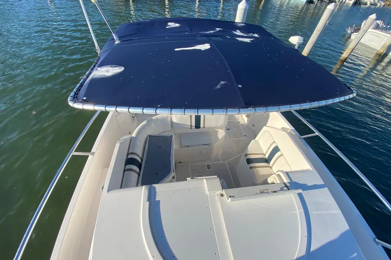 Slide: The Image of 1998 Intrepid 339 boat with canopy, docked on calm water. - 22