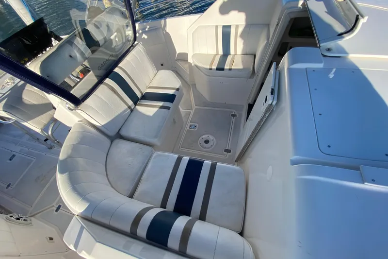 Slide: The Image of 1998 Intrepid 339 boat interior with white and blue cushioned seating. - 25