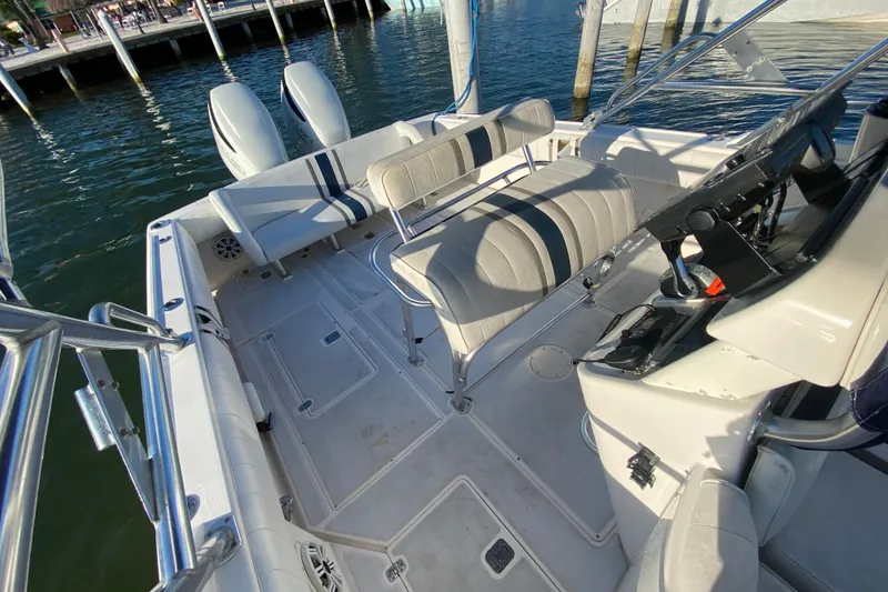 Slide: The Image of 1998 Intrepid 339 boat interior with dual engines, docked by the water. - 26