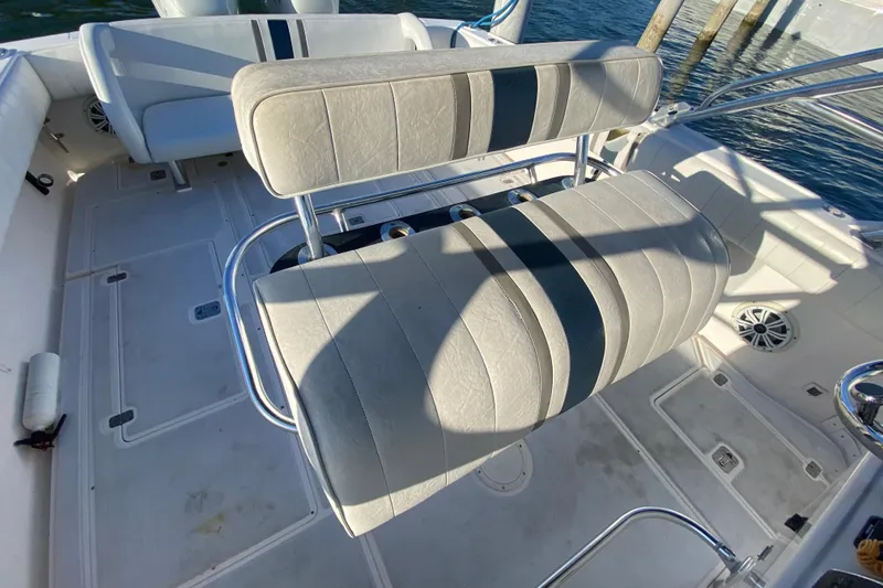 Slide: The Image of 1998 Intrepid 339 boat interior with cushioned seating and stainless steel fixtures. - 28