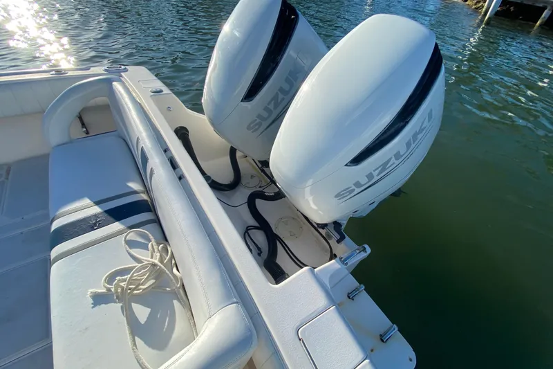 Slide: The Image of 1998 Intrepid 339 boat with twin Suzuki outboard motors on calm water. - 31