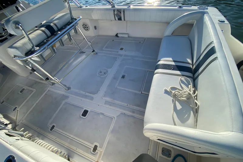 Slide: The Image of 1998 Intrepid 339 boat interior with white seating and storage compartments. - 33