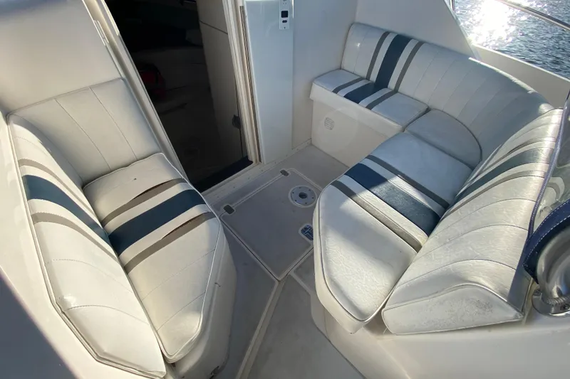 Slide: The Image of Interior seating of a 1998 Intrepid 339 boat with striped upholstery. - 36