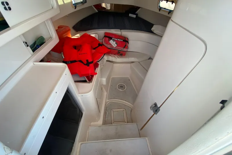Slide: The Image of Interior of a 1998 Intrepid 339 boat with life jackets and storage compartments. - 37