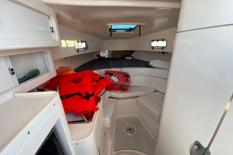 Slide: The Image of 1998 Intrepid 339 boat cabin interior with life jackets and seating area. - 38