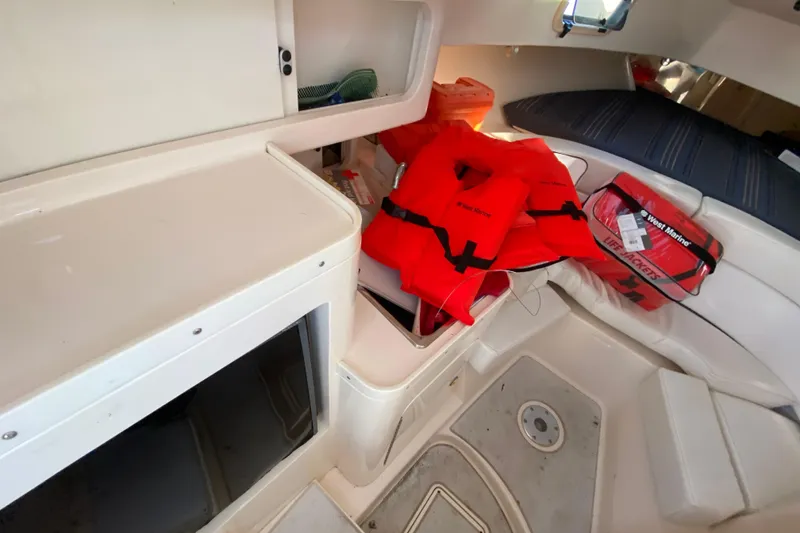 Slide: The Image of Interior of a 1998 Intrepid 339 boat with life jackets and storage area. - 40