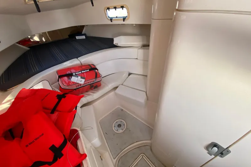 Slide: The Image of Interior cabin of a 1998 Intrepid 339 boat with life jackets and seating. - 41