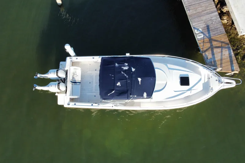 Slide: The Image of Overhead view of a 1998 Intrepid 339 boat docked with twin engines. - 48