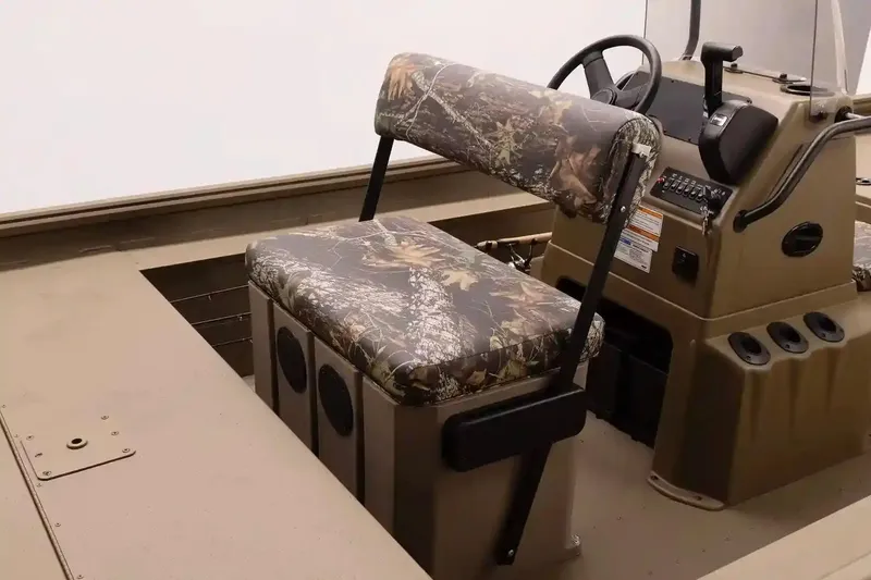 Slide: The Image of 2026 G3 Gator Tough 18 CCT boat interior with storage compartment and camo seating. - 4