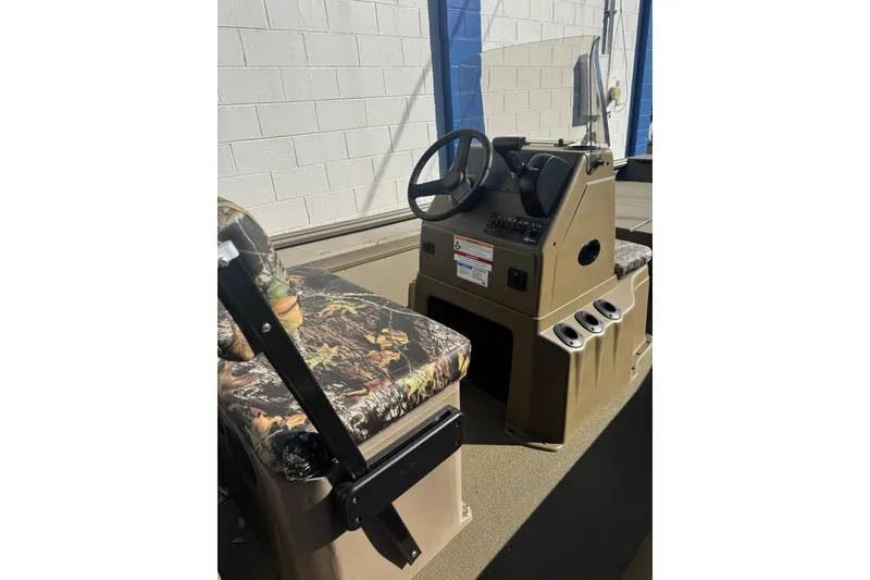 Slide: The Image of 2026 G3 Gator Tough 18 CCT boat interior with camo seating and steering console. - 7