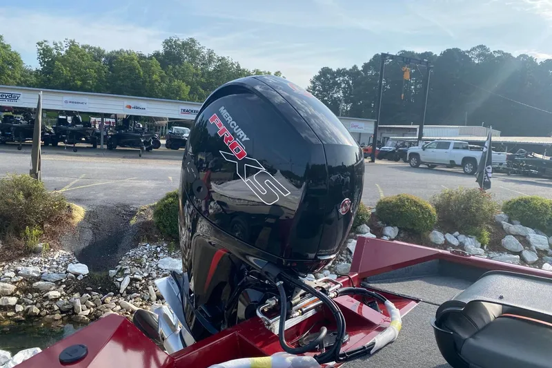 Slide: The Image of 2025 Tracker Pro Team 195 Tournament Edition with Mercury Pro XS engine in a dealership setting. - 2