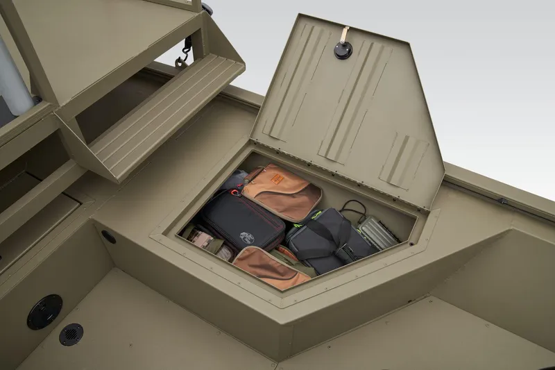 Slide: The Image of Manufacturer Provided Image: 2025 Tracker Grizzly 2072 CC Sportsman storage compartment with gear bags inside. - 23