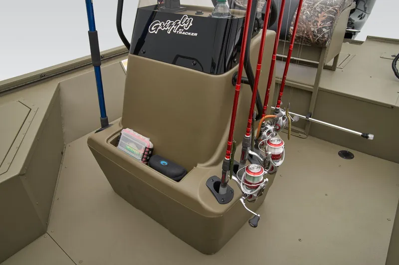 Slide: The Image of Manufacturer Provided Image: 2025 Tracker Grizzly 2072 CC Sportsman boat interior with fishing rods and storage compartments. - 24