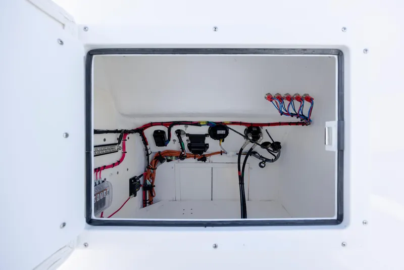 Slide: The Image of Electrical compartment of 2026 Privateer ROAMER II boat with organized wiring and components. - 19