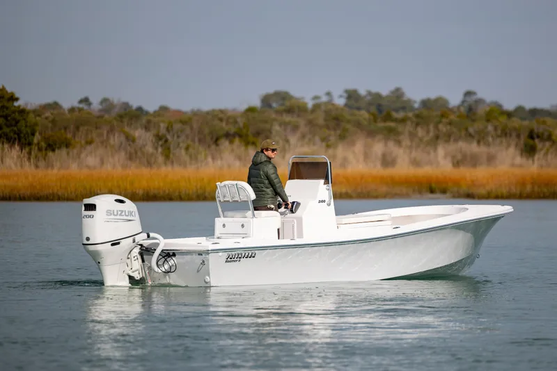 Slide: The Image of 2026 Privateer ROAMER II boat on calm water with Suzuki engine. - 3
