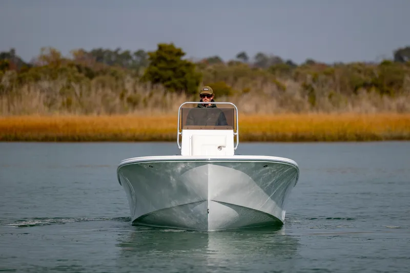 Slide: The Image of 2026 Privateer ROAMER II boat cruising on calm water, with scenic background. - 6