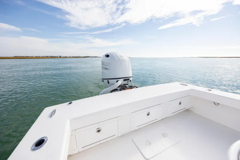 Slide: The Image of Privateer ROAMER II 2026 boat on calm water with clear sky. - 8
