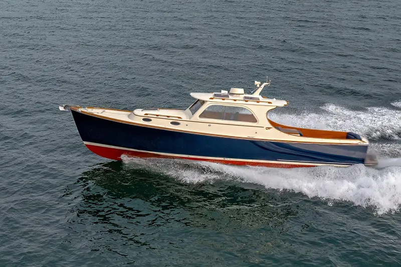 The Image of 2003 Hinckley Picnic Boat EP cruising on open water. - 0