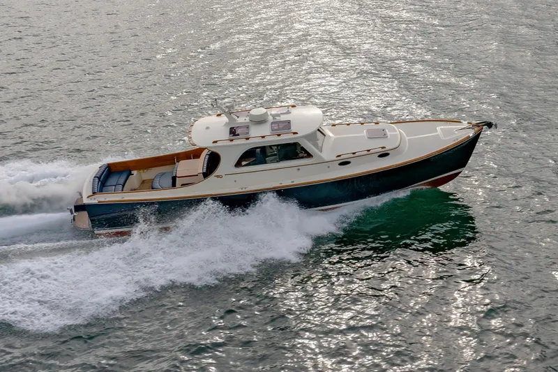 Slide: The Image of 2003 Hinckley Picnic Boat EP cruising on water, showcasing elegant design and performance. - 12