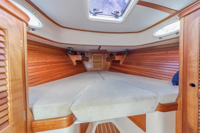 Slide: The Image of Interior cabin of 2003 Hinckley Picnic Boat EP with wooden paneling and skylight. - 39