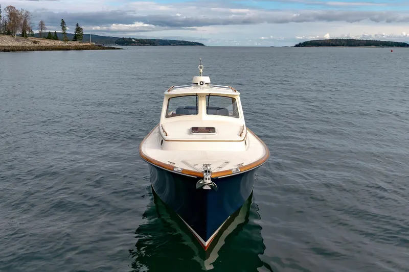 Slide: The Image of 2003 Hinckley Picnic Boat EP on calm waters, scenic coastal background. - 15