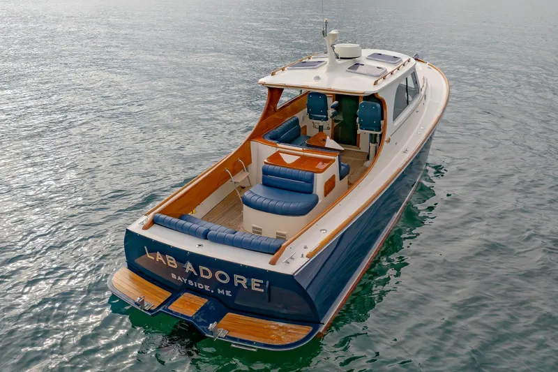 Slide: The Image of 2003 Hinckley Picnic Boat EP on water, featuring elegant design and spacious seating. - 17