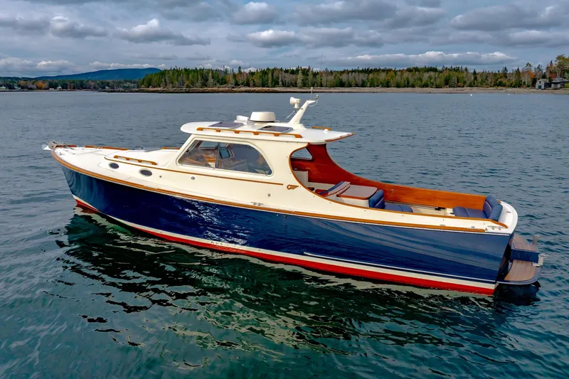 Slide: The Image of 2003 Hinckley Picnic Boat EP on calm water, scenic background, overcast sky. - 19