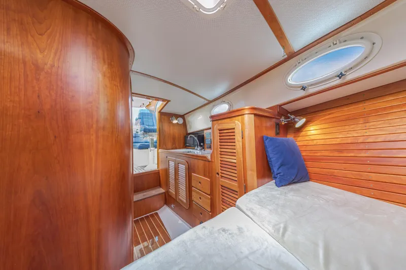 Slide: The Image of 2003 Hinckley Picnic Boat EP interior with wooden finish and cozy cabin space. - 42