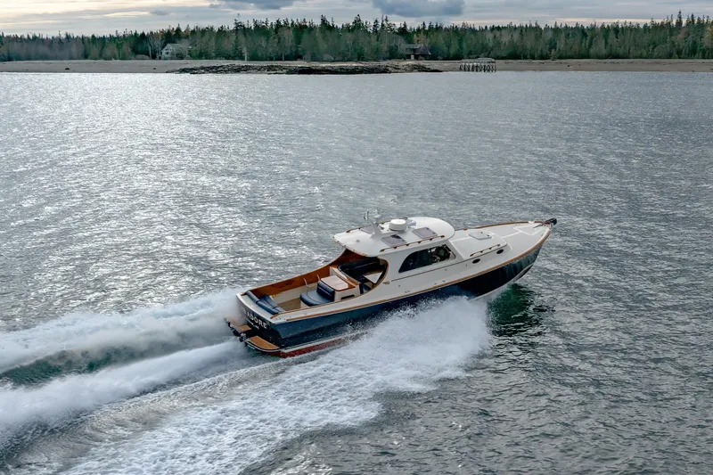 Slide: The Image of 2003 Hinckley Picnic Boat EP cruising on a scenic waterway. - 7