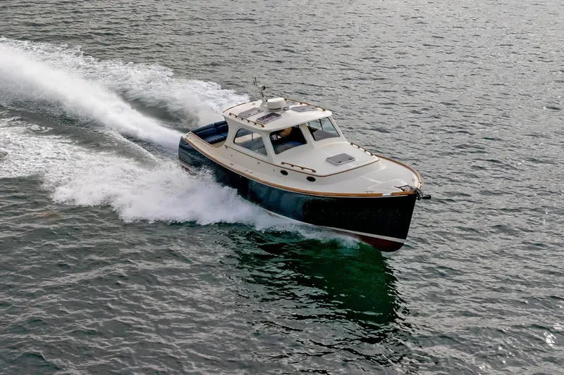 Slide: The Image of 2003 Hinckley Picnic Boat EP cruising on open water, showcasing sleek design and performance. - 9