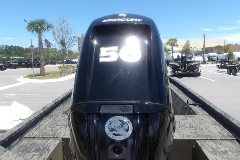 Slide: The Image of 2026 Tracker Grizzly 1648 SC with Mercury outboard engine in a sunny parking lot. - 4