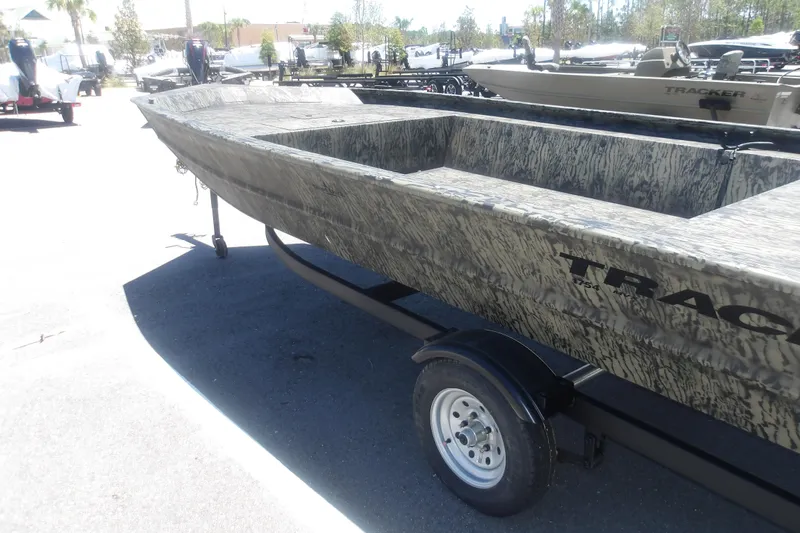 Slide: The Image of 2026 Tracker Grizzly 1648 SC boat on trailer, camo design, outdoor display. - 6
