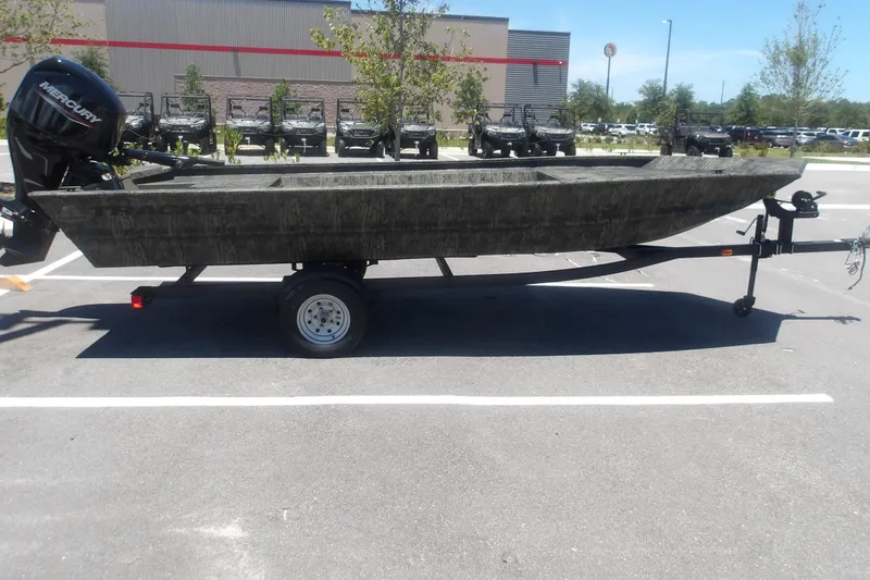 The Image of 2026 Tracker Grizzly 1648 SC boat on trailer in parking lot. - 0
