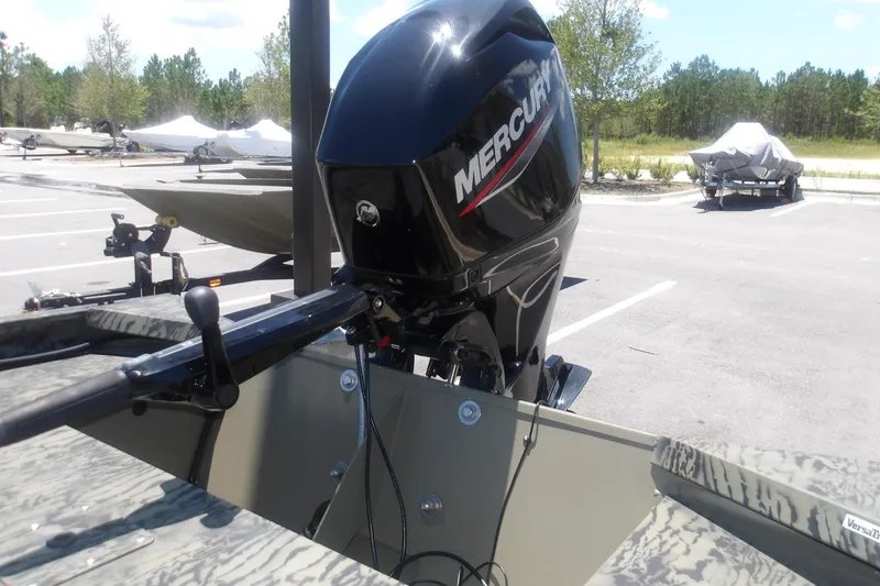 Slide: The Image of 2026 Tracker Grizzly 1648 SC boat with Mercury outboard motor in parking lot. - 8
