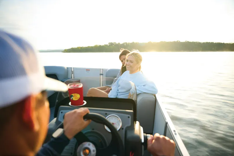 Slide: The Image of 2026 Sun Tracker Party Barge 16 DLX boat seating with cup holders, gray upholstery. - 9