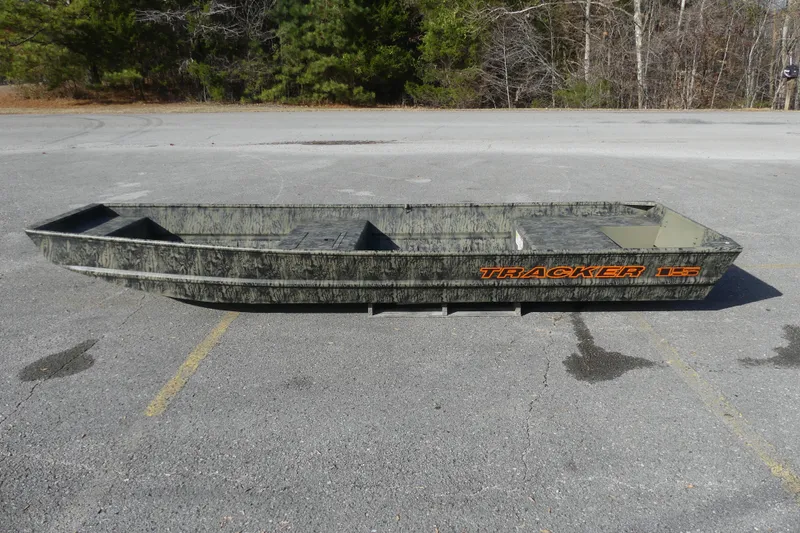 The Image of 2026 Tracker Grizzly 15 Jon boat in a parking lot, featuring a camouflage design. - 0