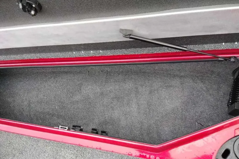 Slide: The Image of 2026 Nitro Z20 XL Pro boat storage compartment with red trim and carpeted interior. - 121