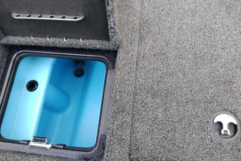 Slide: The Image of Livewell compartment in 2026 Nitro Z20 XL Pro boat, featuring blue interior and carpeted deck. - 123